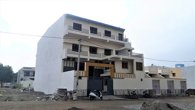 a building with a scooter parked outside chetan agro industries